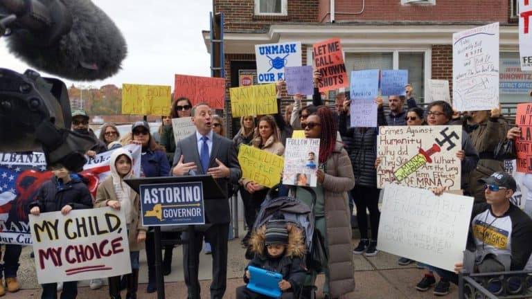 Astorino Photobombed By Woman With Swastika Sign at Anti-Vax Event